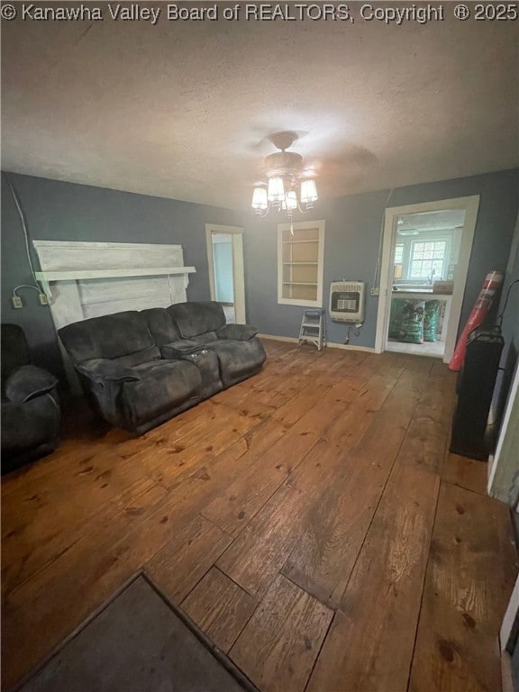 living room featuring a textured ceiling, heating unit, and hardwood / wood-style flooring