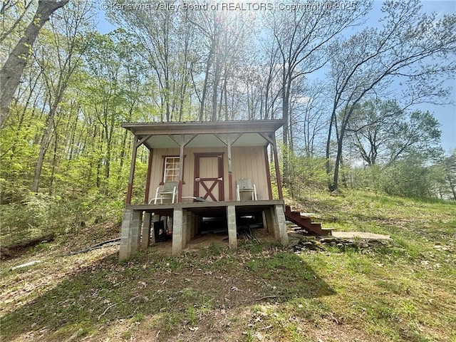 view of outbuilding featuring stairs