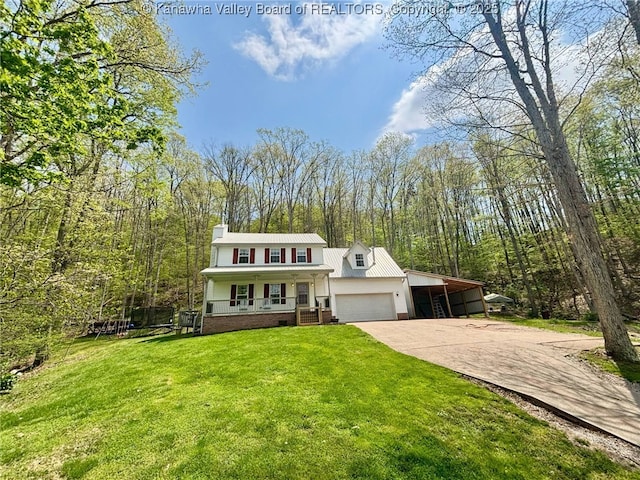 traditional-style home featuring a front lawn, covered porch, a chimney, concrete driveway, and a carport