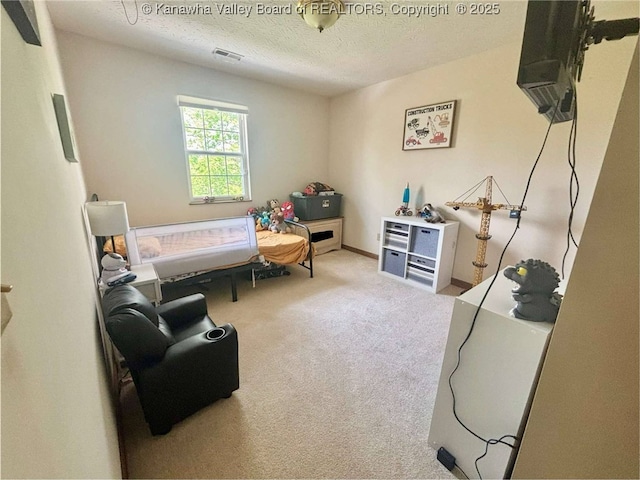 bedroom featuring visible vents, carpet flooring, and a textured ceiling