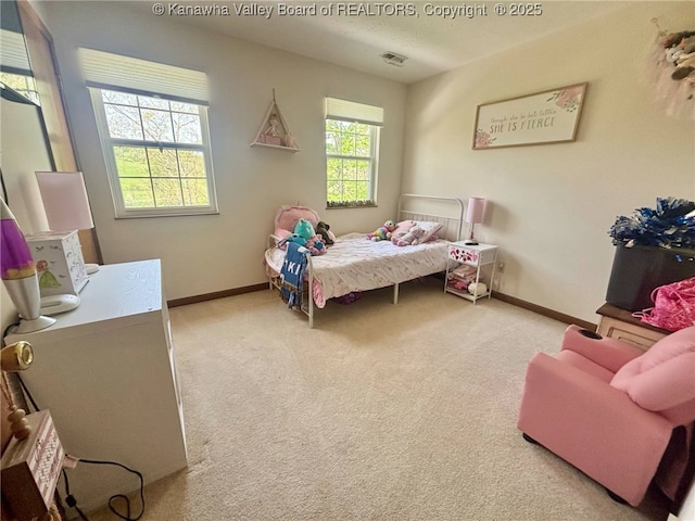 bedroom with baseboards, visible vents, and carpet