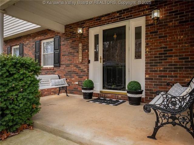 5339 Pioneer Dr, Cross Lanes, WV 25313 - view of exterior entry with brick siding and a porch