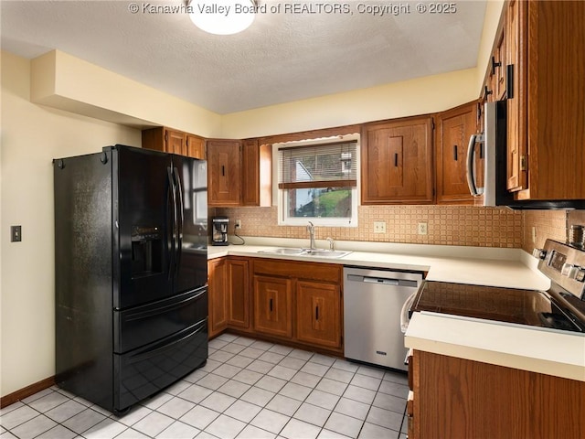 5339 Pioneer Dr, Cross Lanes, WV 25313 - kitchen with a sink, brown cabinetry, stainless steel appliances, decorative backsplash, and light tile patterned floors