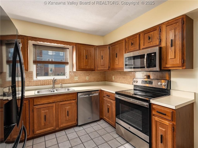 5339 Pioneer Dr, Cross Lanes, WV 25313 - kitchen featuring a sink, brown cabinetry, and stainless steel appliances