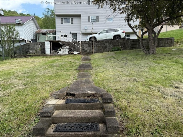 view of yard featuring fence and stairs