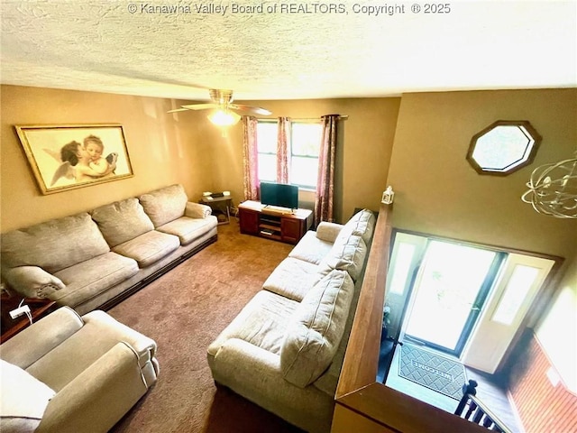 carpeted living area featuring a textured ceiling and ceiling fan