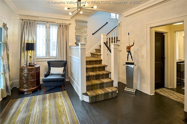 sitting room with ornamental molding, wood finished floors, and stairway
