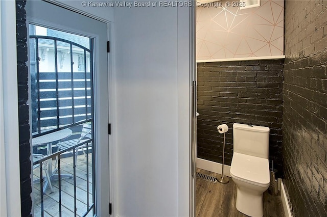 bathroom featuring wood finished floors and toilet