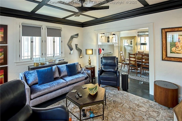 living room with crown molding, a ceiling fan, and wood finished floors