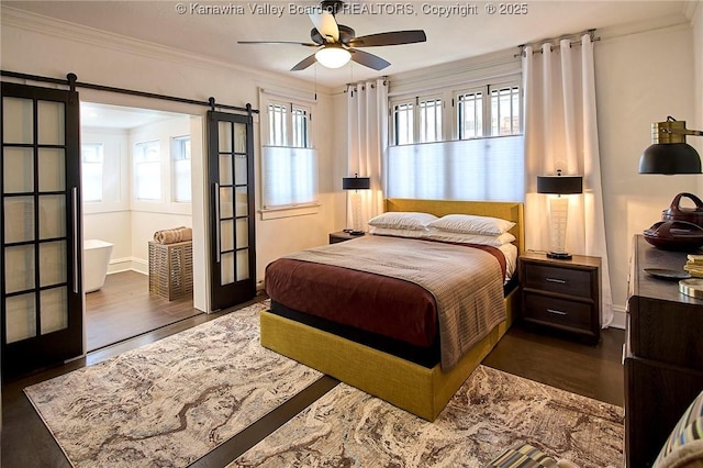 bedroom featuring a ceiling fan, dark wood-style flooring, a barn door, baseboards, and ornamental molding