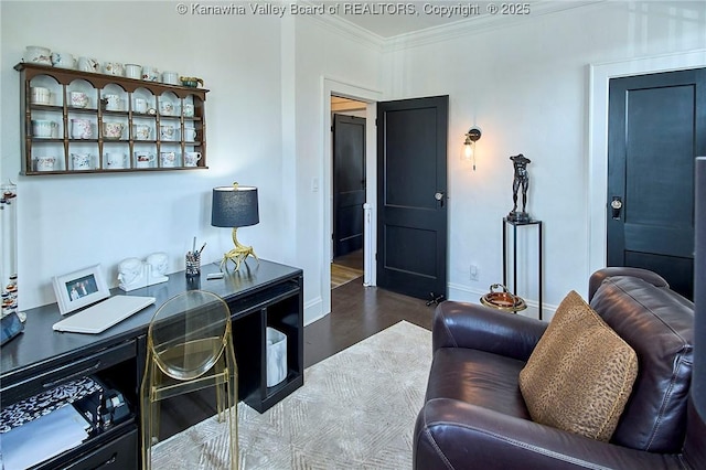 living area featuring baseboards, ornamental molding, and wood finished floors