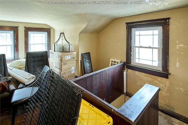 stairway with a healthy amount of sunlight and vaulted ceiling