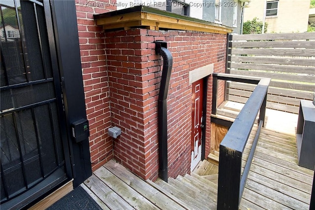 view of exterior entry with brick siding