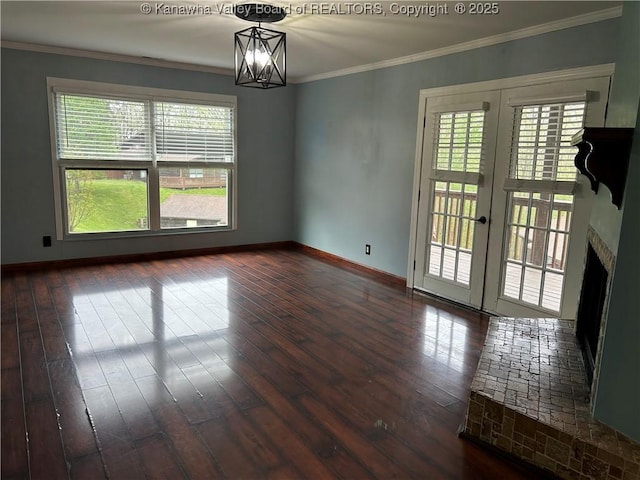 unfurnished room with baseboards, plenty of natural light, and dark wood-type flooring