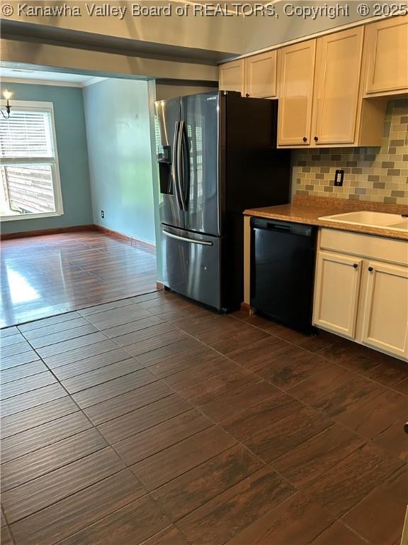 kitchen featuring tasteful backsplash, dishwasher, light countertops, baseboards, and a sink