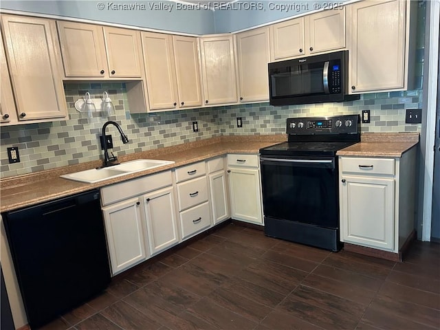 kitchen featuring light countertops, white cabinets, a sink, backsplash, and black appliances