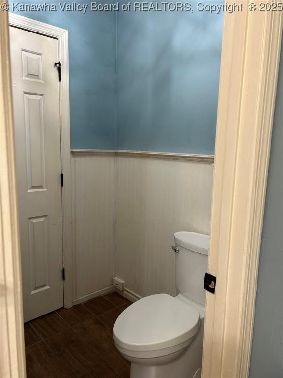 bathroom with wainscoting and toilet