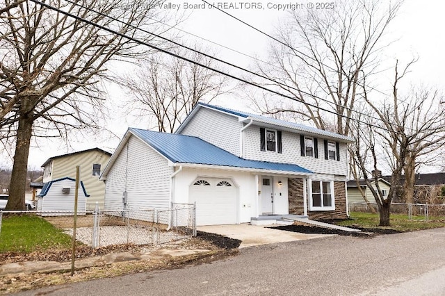 traditional-style home featuring metal roof, a garage, fence, concrete driveway, and stone siding