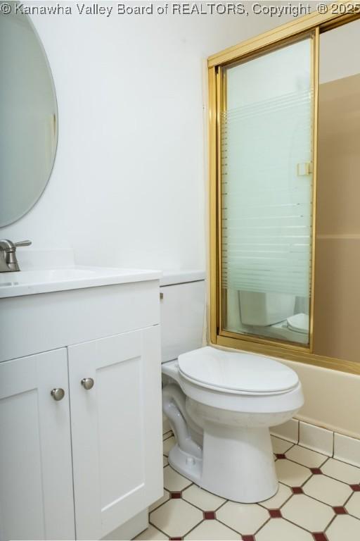 full bath with an enclosed shower, toilet, tile patterned floors, and vanity