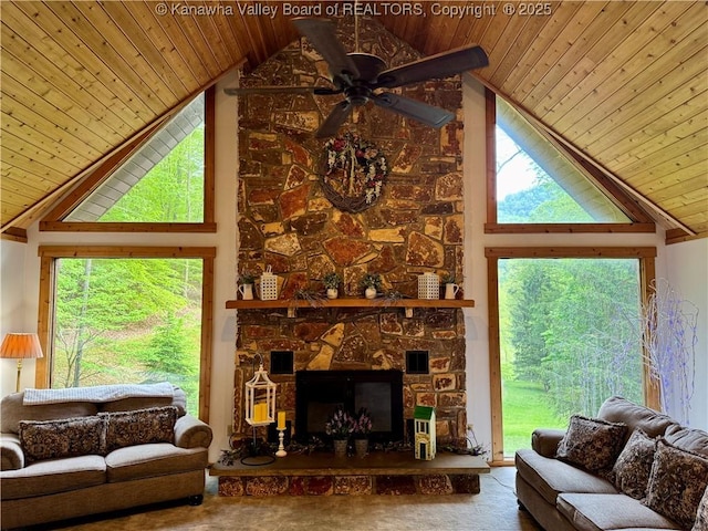 living area with a ceiling fan, high vaulted ceiling, wooden ceiling, and a stone fireplace