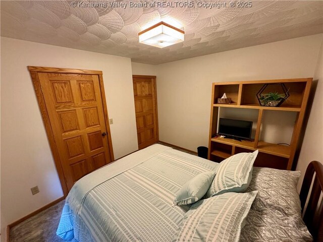 bedroom with baseboards and carpet