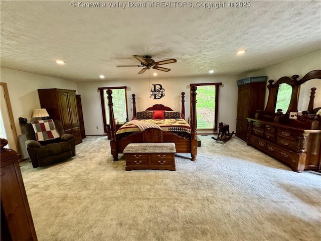 bedroom with recessed lighting, a textured ceiling, light colored carpet, and a ceiling fan