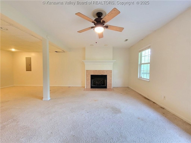 unfurnished living room with a ceiling fan, light carpet, electric panel, and a fireplace