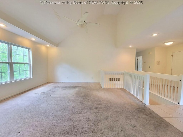 tiled empty room with carpet floors, ceiling fan, recessed lighting, and high vaulted ceiling
