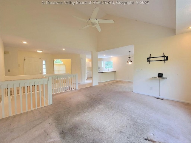 empty room with carpet flooring, ceiling fan, high vaulted ceiling, recessed lighting, and visible vents