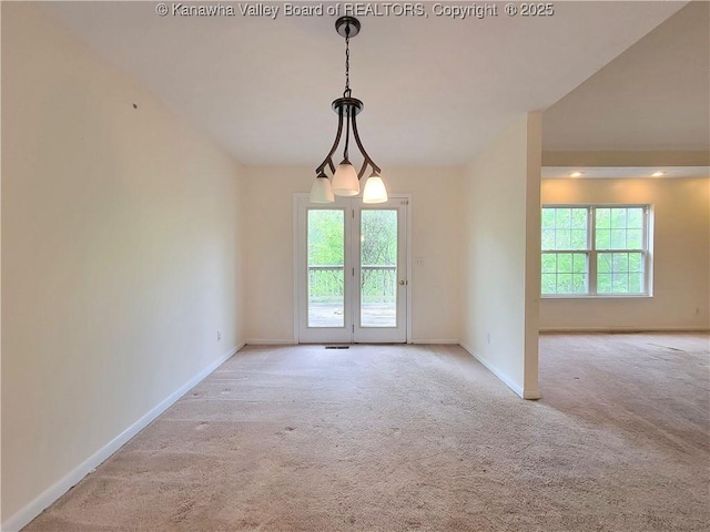 carpeted empty room featuring baseboards