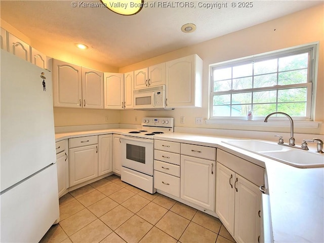 kitchen featuring light tile patterned flooring, white appliances, recessed lighting, light countertops, and a sink