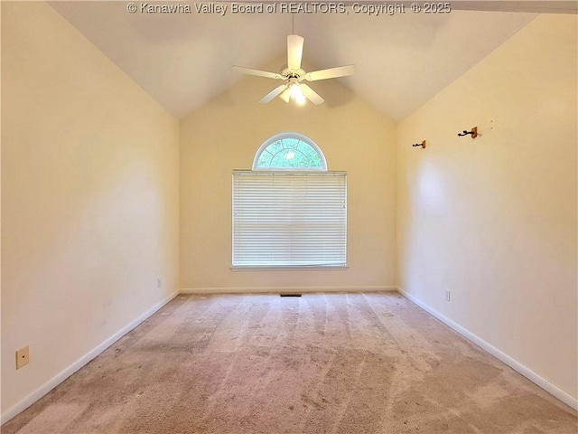 spare room with carpet floors, a ceiling fan, baseboards, and vaulted ceiling