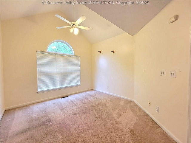unfurnished room featuring carpet floors, a ceiling fan, baseboards, lofted ceiling, and visible vents