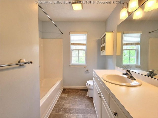 bathroom featuring bathtub / shower combination, a wealth of natural light, and toilet