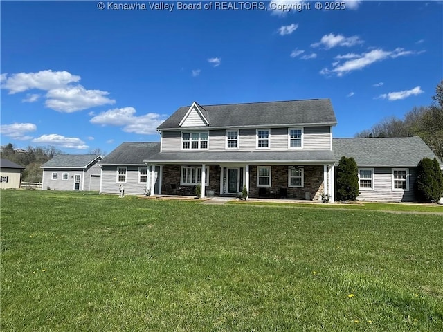 colonial-style house featuring a porch, stone siding, and a front lawn