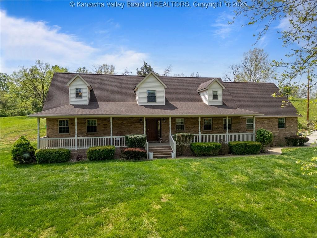 23 Hidden Acres Ln, Huntington, WV 25704 - view of front facade with a front yard, a porch, and brick siding