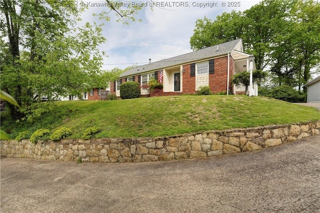 single story home featuring a front lawn and brick siding