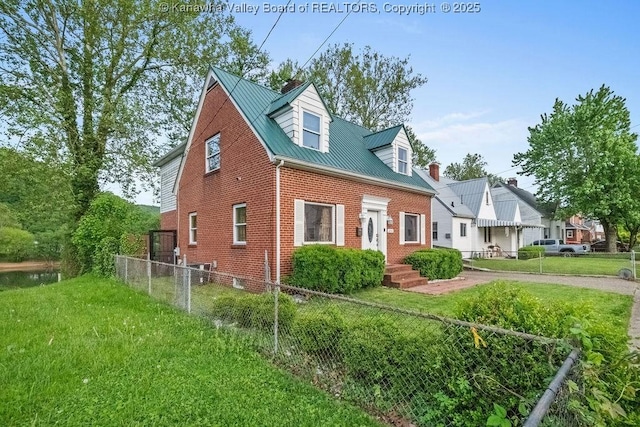 view of home's exterior with a lawn, brick siding, fence, and metal roof