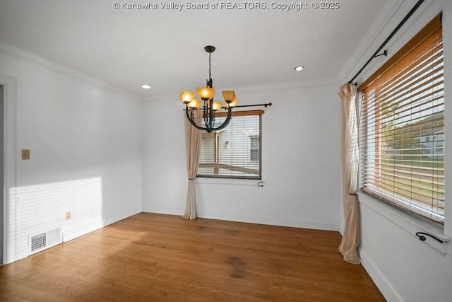 unfurnished room featuring an inviting chandelier, plenty of natural light, ornamental molding, and visible vents