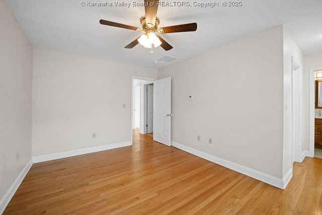 spare room featuring baseboards, ceiling fan, and light wood-style flooring