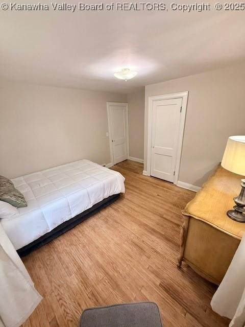 bedroom featuring baseboards and wood finished floors
