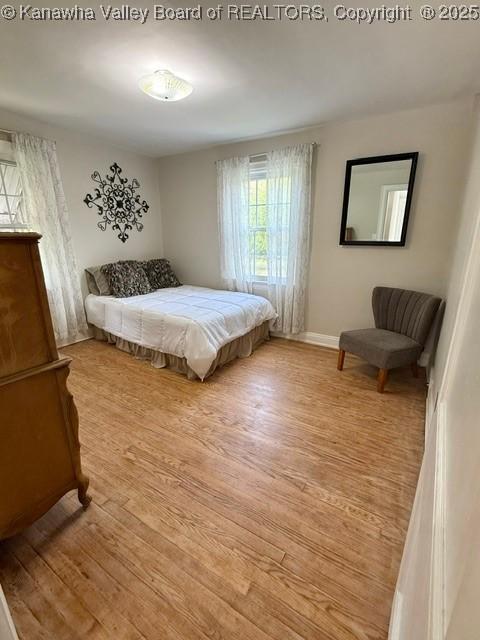 bedroom featuring baseboards and wood finished floors