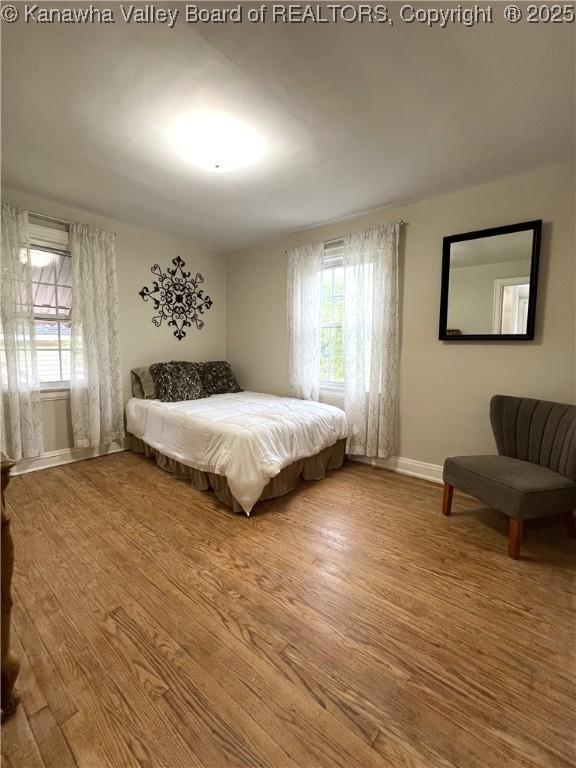 bedroom featuring baseboards and wood finished floors