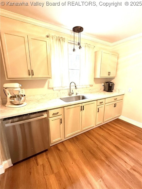 kitchen with crown molding, a sink, light wood-style floors, light countertops, and dishwasher