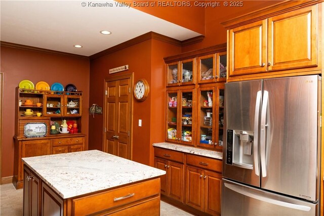 2804 Hash Ridge Rd, Barboursville, WV 25504 - kitchen featuring stainless steel fridge, ornamental molding, light stone countertops, and brown cabinets
