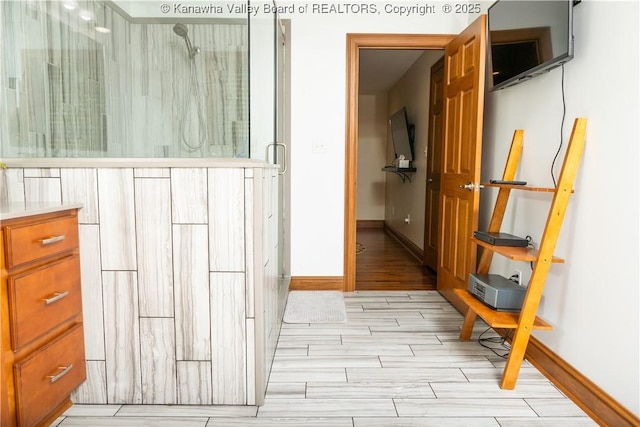 2804 Hash Ridge Rd, Barboursville, WV 25504 - bathroom featuring baseboards, a stall shower, and wood finish floors