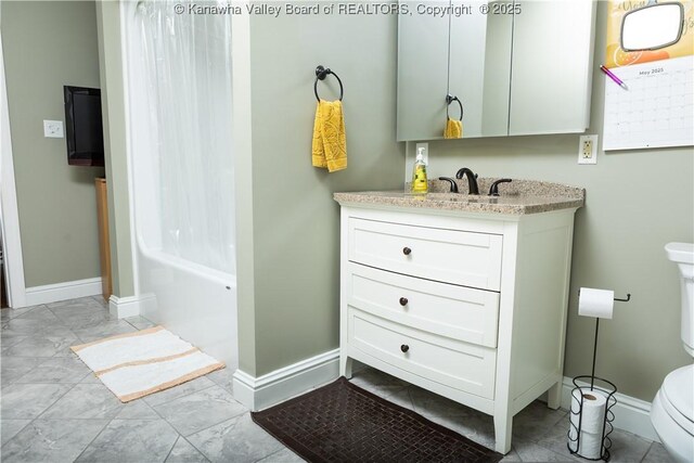 2804 Hash Ridge Rd, Barboursville, WV 25504 - bathroom with vanity, marble finish floor, toilet, baseboards, and shower / tub combo