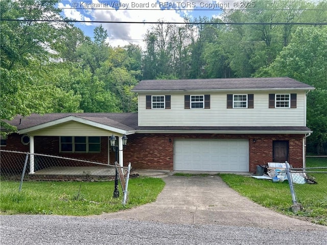 405 Crestview Dr, Charleston, WV 25302 - tri-level home featuring an attached garage, a front lawn, fence, and driveway