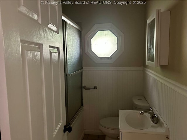 405 Crestview Dr, Charleston, WV 25302 - bathroom featuring wainscoting, tile patterned floors, vanity, toilet, and enclosed tub / shower combo