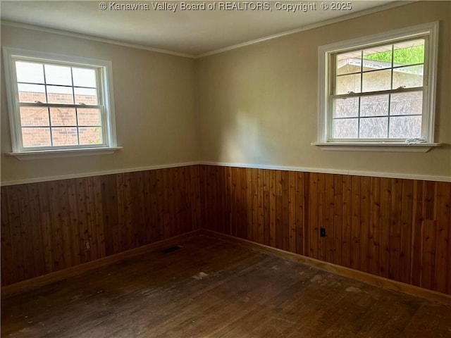 405 Crestview Dr, Charleston, WV 25302 - empty room with wood finished floors, a healthy amount of sunlight, and a wainscoted wall